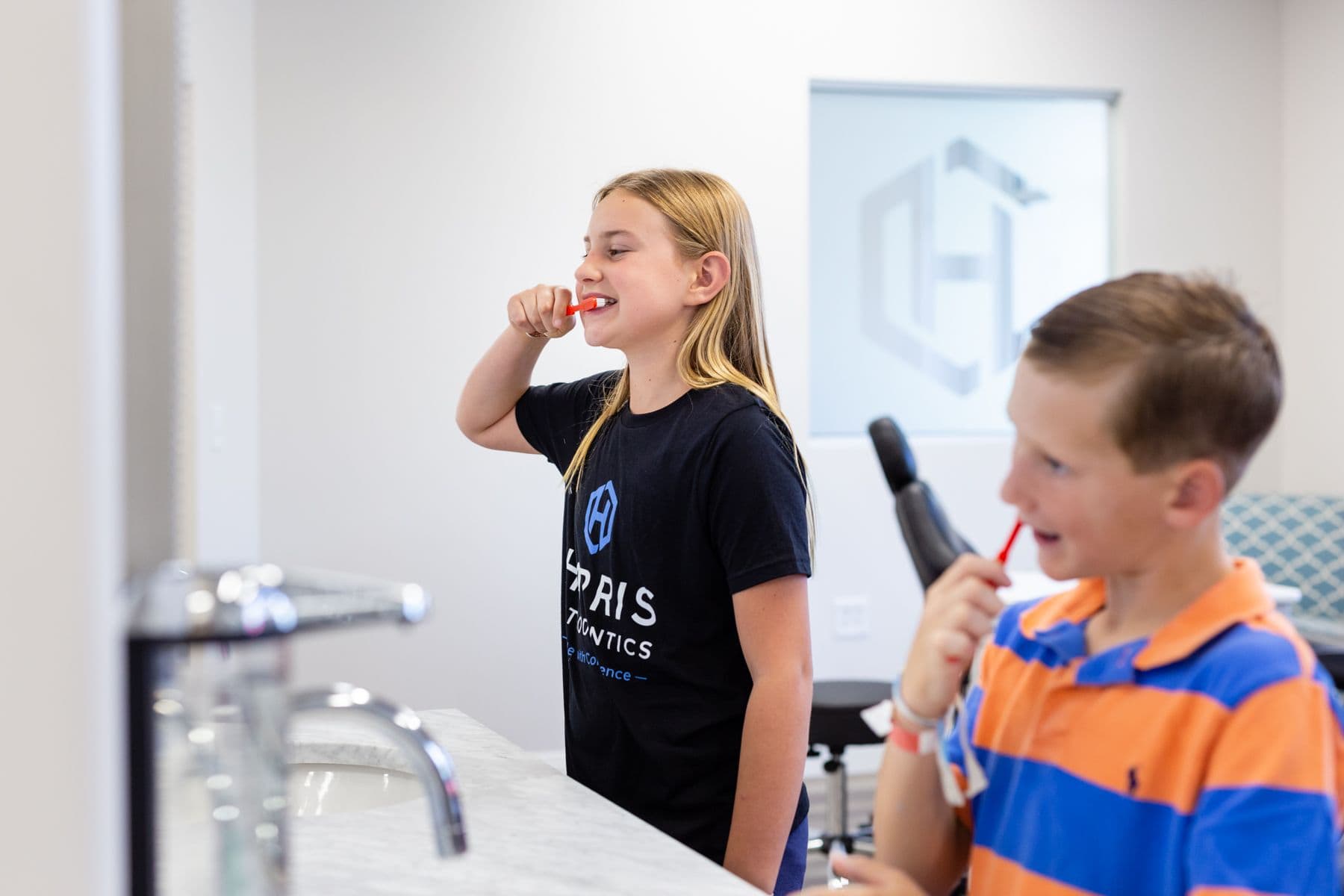 Two children brushing their teeth